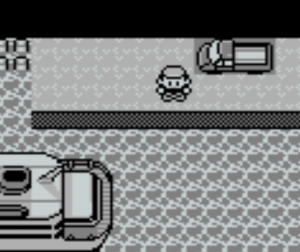 An image from Pokémon Red or Blue. The player character stands at a dock next to a truck, staring out at the water.