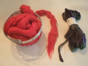 Wool roving balled and ready to knit, next to the extra skein of yarn for the COWYAK.