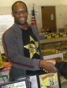 ECBACC VP Akin Brown shakes hands with a child, http://ecbacc.com/wordpress3/2010/ecbacc-at-kids-comic-con-2010/