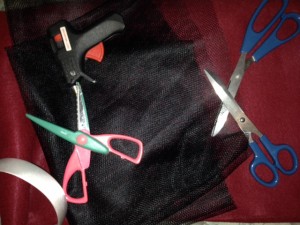 Craft felt, glue gun, many scissors, headband, and black veiling-mesh type stuff