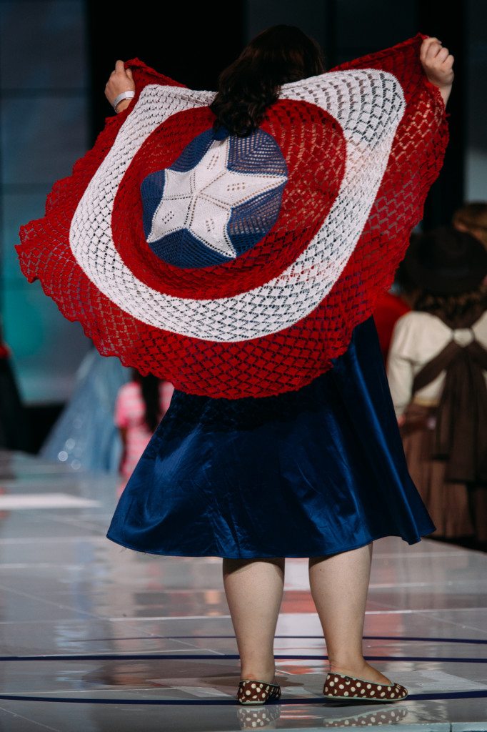 The author wearing the Her Universe Captain America dress from Torrid, and a hand-knit Captain America shield.