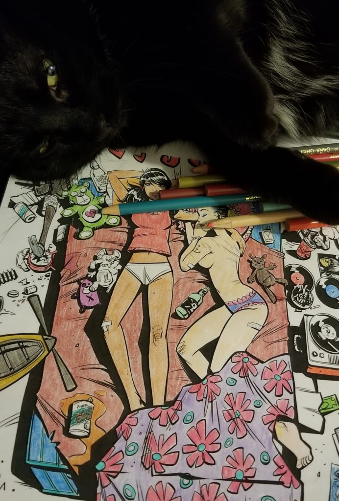 A cat overlooks a Tank Girl Coloring Book page
