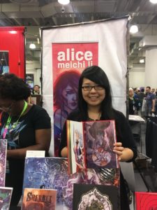 Li displays her page of 1001 Knights at her booth