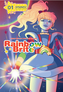 Rainbow Brite standing confidently right-of-center on a dark blue background; the light refracts from her palm and causes a prismatic effect.