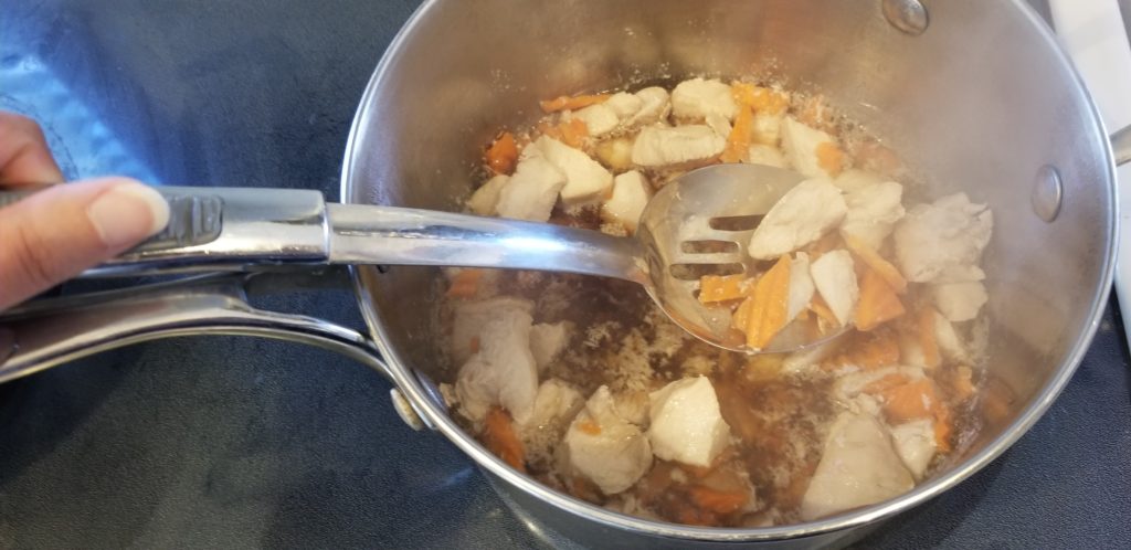 chicken and carrots in a pot
