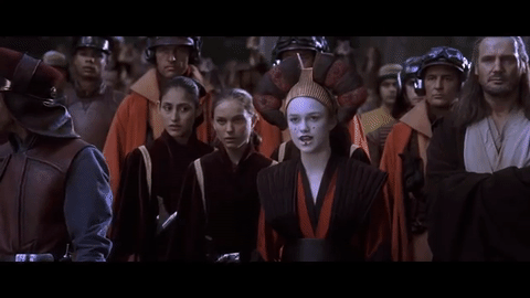 Padmé reveals herself to be the true queen, stepping out in front of Sabé, who is dressed as Amidala