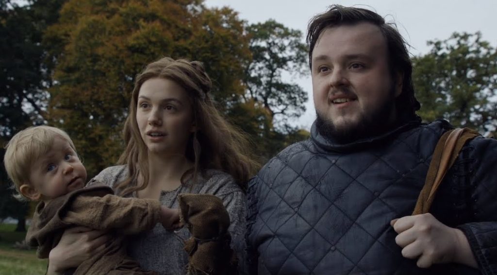 Samwell, with Gilly holding her baby beside him, looks forward happily
