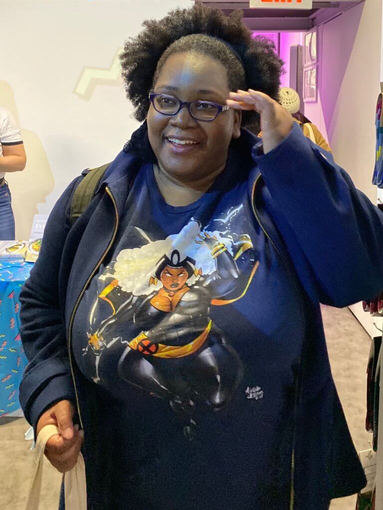 A person displays a shirt in which the character Storm is fabulous