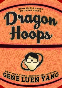 Cover of graphic novel Dragon Hoops features a close up of a basketball in the background with a cartoon face with short black hair glasses and no mouth under the title on top.