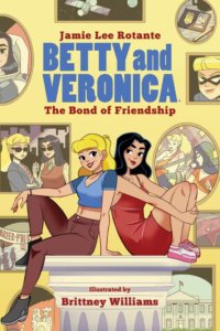 Betty Cooper, a blond-haired teen, sits back to back with her best friend, the brunette veronica lodge, in front of a wall filled with picture of the two of them together.