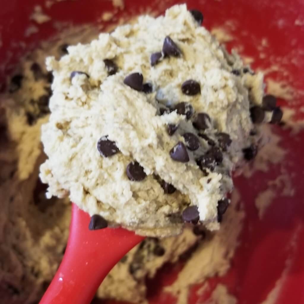 A spoonful of cookie dough with lots of chocolate chips.