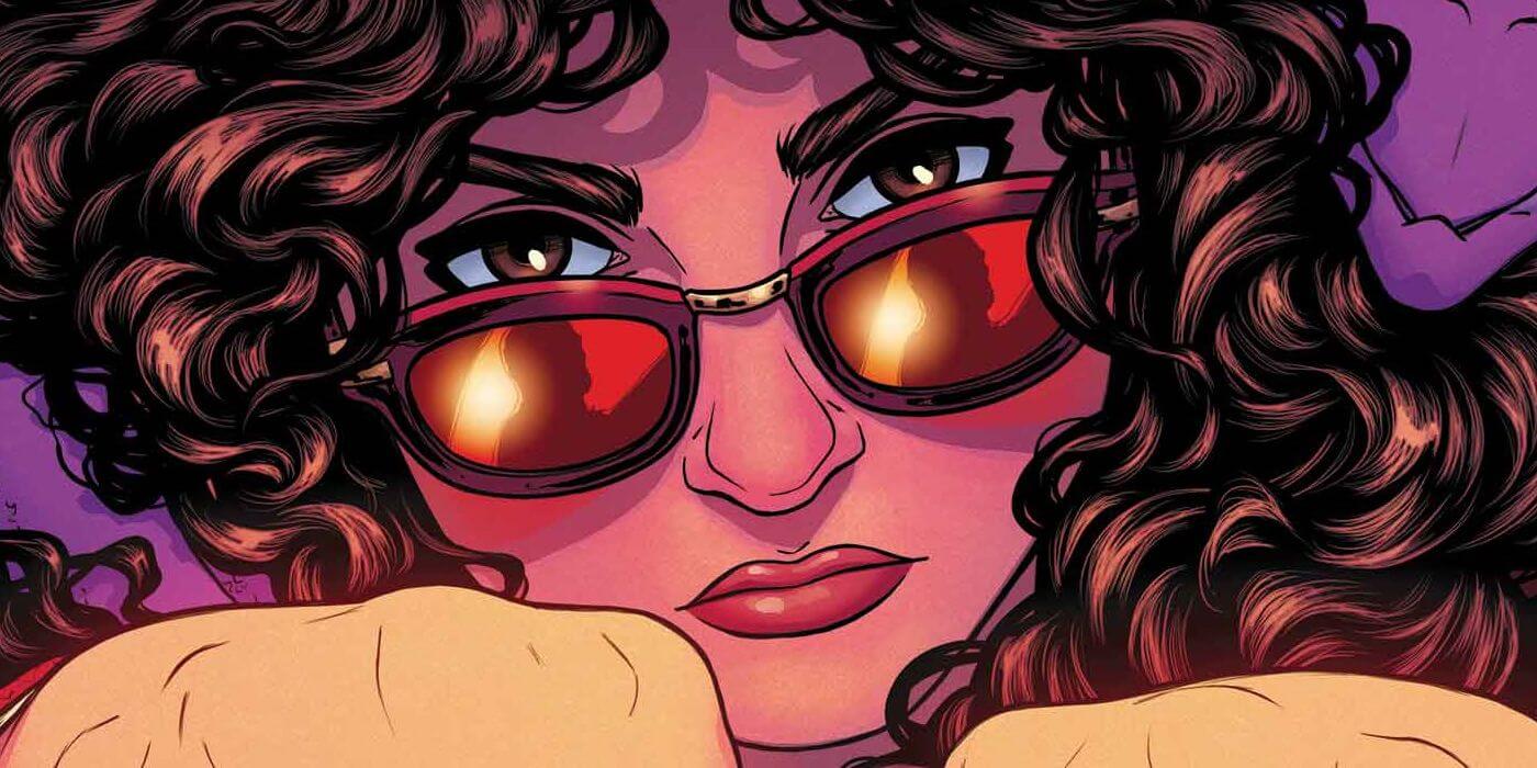 Kate Pryde with curly hair, wearing sunglasses and looking determined and vengeful