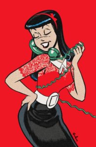 Veronica Lodge, a white brunette teenager, stands before a red backdrop talking into a blue-green colored phone, the cord wrapped around her body. She smiles and poses with a hand on her hip, wearing a red lace blouse that matches the backdrop, a white bow in her hair, white blouse, wide white belt and black skirt