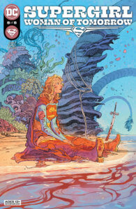 Supergirl sitting sad and battle damaged on an alien beach with a sword stuck in the sand