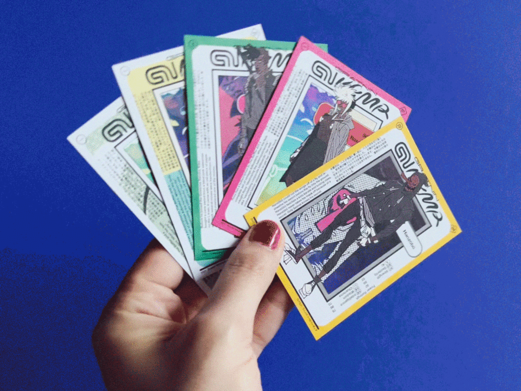 hands holding 5 shiny trading cards