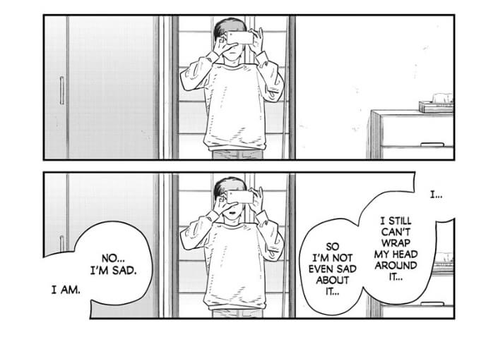 A two-panel sequence of a young man holding a smartphone to a mirror. In the second panel, dialogue reads from right to left, "I... I still can't wrap my head around it... So I'm not even sad about it... No... I'm sad. I am."