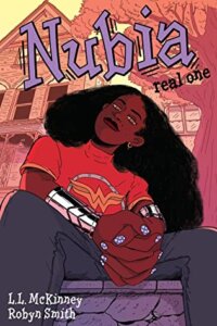 Cover of Nubia: Real One by L. L. McKinney and Robyn Smith. Cover illustration shows a low-angle image of DC's heroine Nubia in casual streetwear.