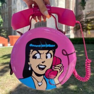 A model holds a purse with Veronica's face on it