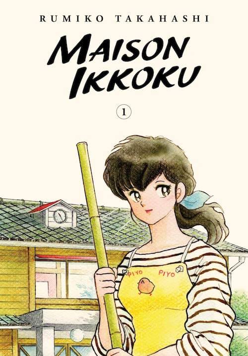 Kyoko stands in front of Maison Ikokku wearing her apron and holding a broom handle.