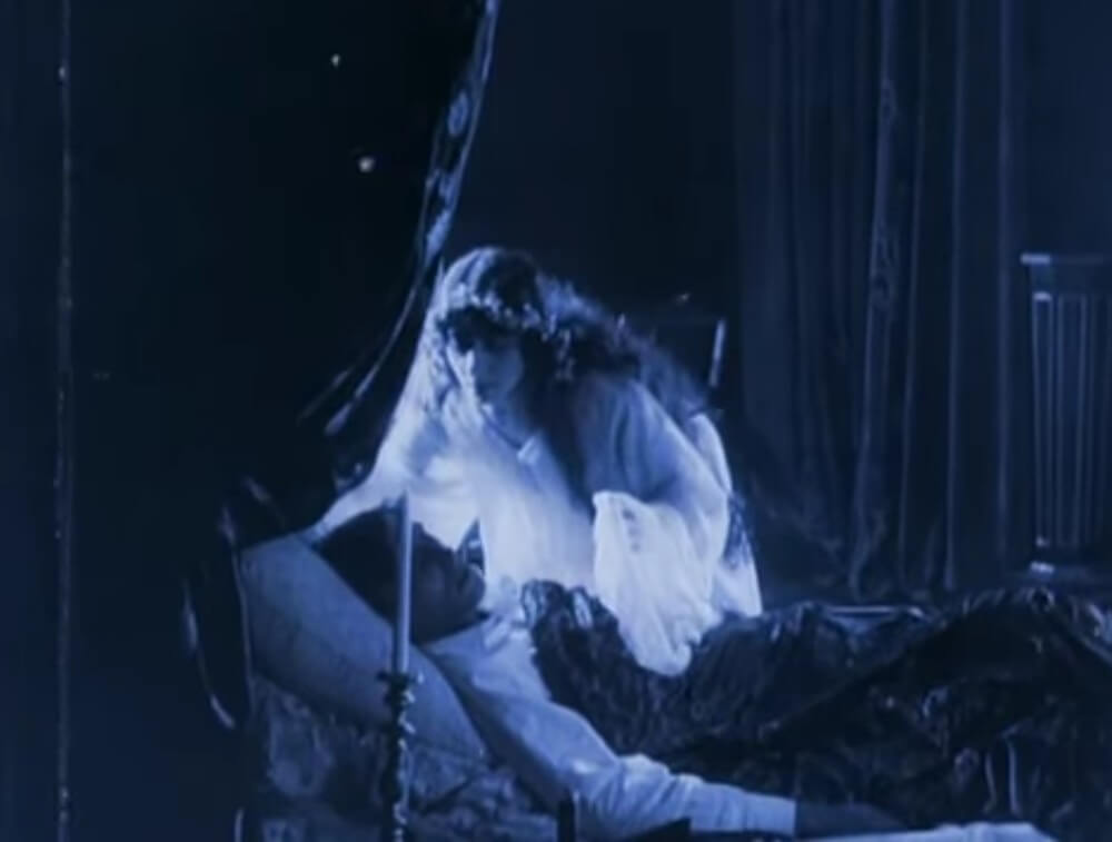 Still from the film After Death (1915). Vera Karalli, as a ghost, looks down on the sleeping form of film''s hero (Vitold Polonsky)