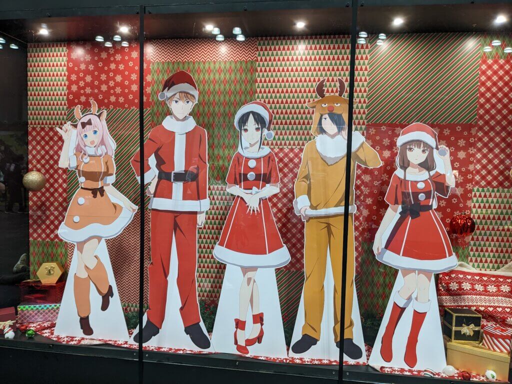 Cardboard standees of the core cast of Kaguya-sama: Love is War in Christmas attire.