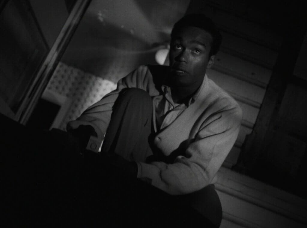 Still from the film Night of the Living Dead. Ben (Duane Jones) kneels. Obtained from Fancaps.net.
