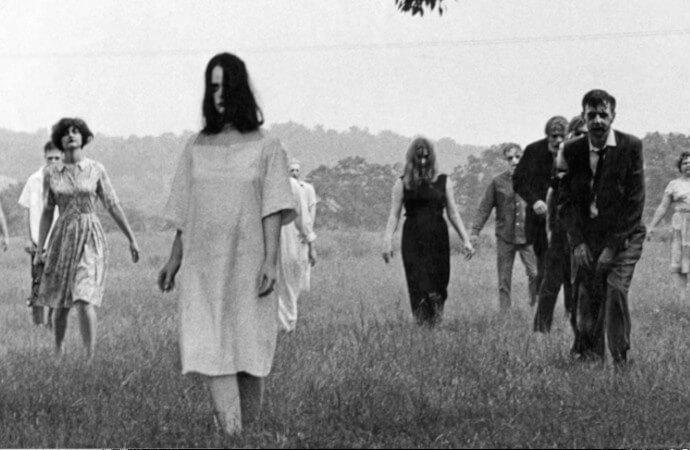 Still from the 19698 film Night of the Living Dead showing zombies in a field.