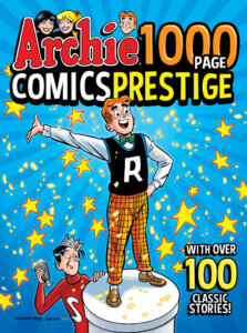 Thin white redhaired teen Archie Andrews stands on a raised white podium wearing his standard outfit - checked yellow pants, tan loafers, a black letterman sweater, a white shirt and an aqua bowtie. He proudly gestures behind him. At the foot of the pedestal dark-haired white Jughead Jones holds a milkshake up in a toast, his red sweater and grey foolscap in place. Behind Archie is a blue background, with lots of yellow stars floating over his head.