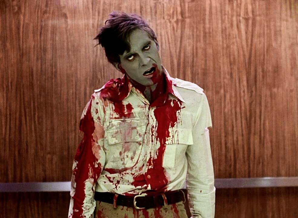 Still from the 1978 film Dawn of the Dead showing a zombie standing drenched in blood.