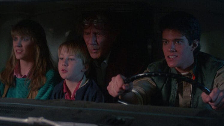 Still from the film Return of the Living Dead Part II. The main characters inside a car.