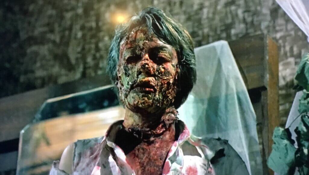 Still from the film Zombi 3 showing a zombie in close-up.