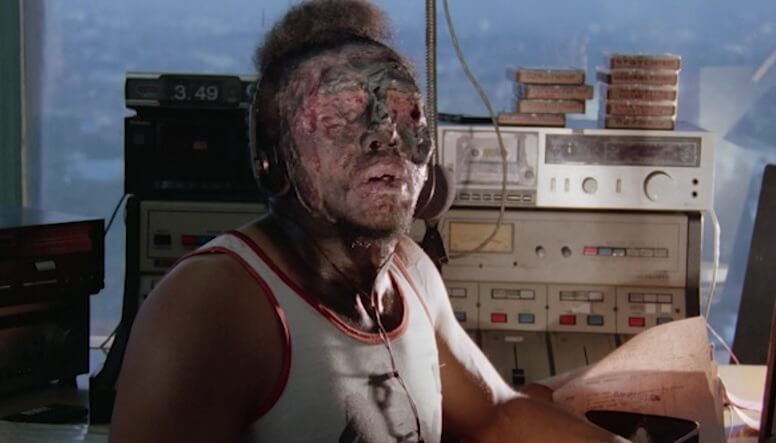 Still from the film Zombi 3 showing a zombified radio DJ.