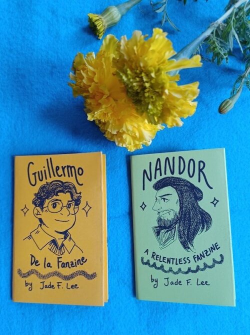 Jade F Lee's zines underneath a flower.