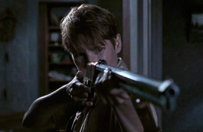 Still from the 1990 remake of Night of the Living Dead. Patricia Tallman as Barbara holds a gun.