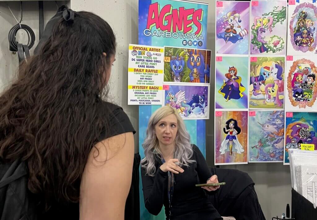 Agnes Garbowska discusses a custom piece with a fan 