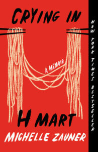 the cover of Crying in H Mart by Michelle Zauner shows two sets of chopsticks holding ends of the same noodles, against a red background. 
