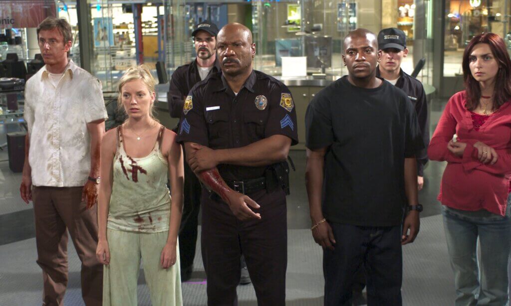 Still from the 2004 film Dawn of the Dead showing the cast standing in a quiet moment.
