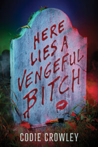The cover of Here Lies a Vengeful Bitch by Codie Crowley shows the title in all caps as though written in blood or lipstick on a headstone