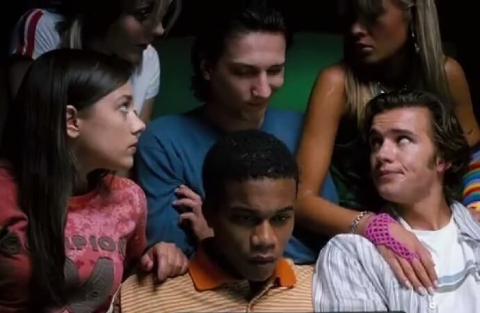 Still from the film Return of the Living Dead: Necropolis. Shows the main characters gathered together.