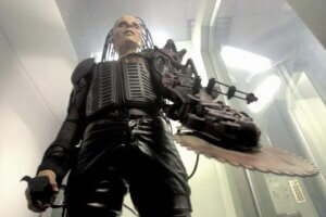 Still from the film Return of the Living Dead: Necropolis. Shows a cyborg zombie with buzzsaw hand.