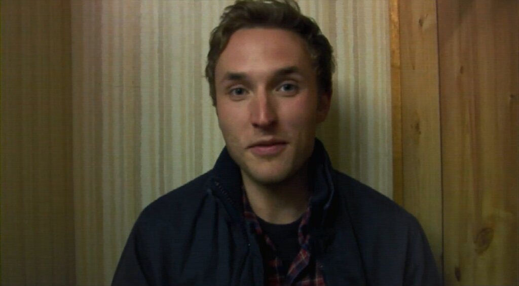 Still from the film Diary of the Dead showing a young man facing the camera, distorted by scanlines.