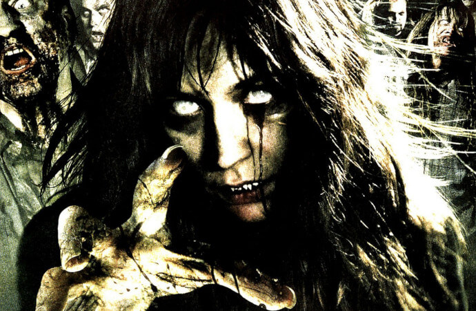 Detail from the DVD cover of the film Survival of the Dead, with a white-eyed zombie reaching towards the viewer.